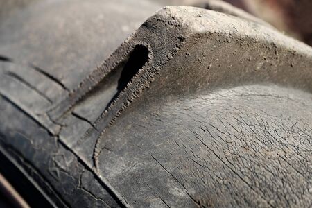 Old wheel with spoiled rubberの写真素材