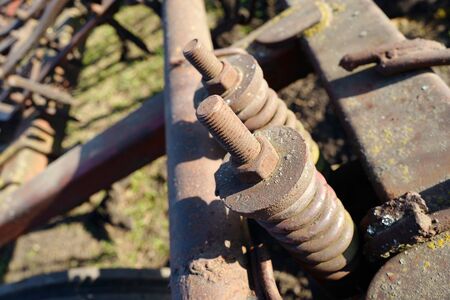 Rusty bolts and nuts on springs of agricultural machinery transportation partsの写真素材