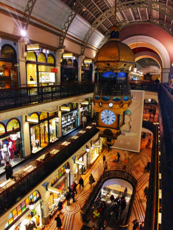 Interior of a shopping mall with a large clockの写真素材