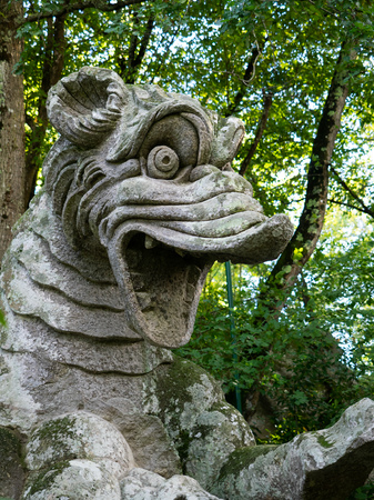 A stone statue deep in the woodsの写真素材