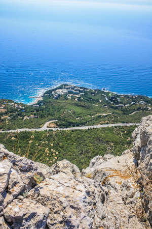 Mediterranean landscape. Forested rocks of the Black Sea coast of the southern coast of the Crimean Peninsula on a clear sunny day. View down from the rocky mountains to the seaの写真素材