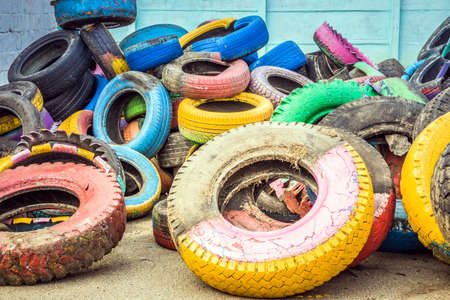 Pile of old multicolored car tires dug in playgrounds. Multicolor used tires. various sizes colored tires.の写真素材