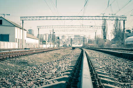 Railway tracks in the city with track bed. Gravel and switch at a railroad crossing.の写真素材