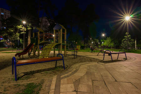 Children playground at night in the green city parkの写真素材
