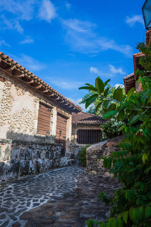 Villa with a red roof in the jungle. Old European-style house in tropical latitudes. Living in the wild. Brick house in the tropics. Dominican Republicの写真素材
