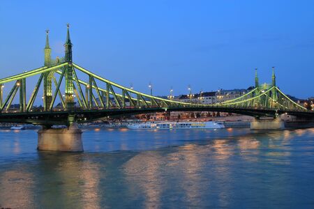 The picture was taken in Budapest. The photo shows the evening view of the Bridge of Liberty across the Danube River.の写真素材