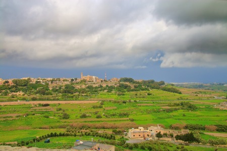 The photo was taken from the wall of the ancient city of Mdina in Malta. The picture shows the thunderstorm rallied over the valley lying at the foot of the city.の写真素材