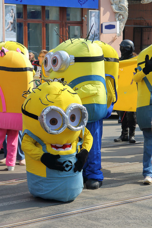 ODESSA, UKRAINE - APRIL 01, 2019. The photo was taken in Odessa at the traditional festival of humor and laughter called Humorina. In the picture, the actors in minion costumes are walking along a city street.のeditorial素材