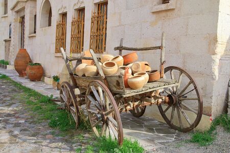 The photo was taken in Turkey, in the city of Uchisar. The picture shows an old cart loaded with ceramic dishes.の写真素材
