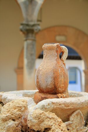 Photo taken in the city of Palma. The picture shows the original decor of the fountain in the form of a jug. The jug has a red tinge due to mineral water.の写真素材