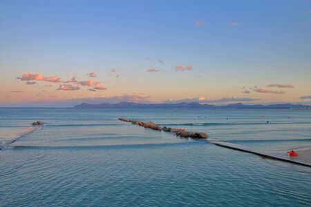 Photo taken on the island of Palma de Mallorca. The picture shows a picturesque view of the sea at sunset. The mountains are visible in the distance.の写真素材