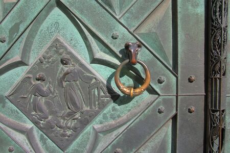 Photo taken in the old part of the city of Krakow in Poland. The picture shows a part of an old metal masterfully decorated door leading to an old warehouse.の写真素材