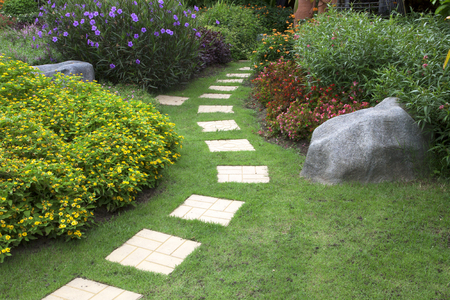 Pathway in a Peaceful Green Park with flowers.の写真素材