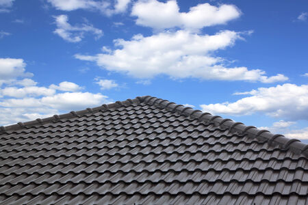 construction of black rooftop against blue sky background.の写真素材