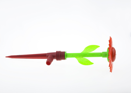 Plastic sprinklers shaped flowers isolated on white background.の写真素材