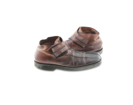 Old leather shoes isolated on white background.の写真素材