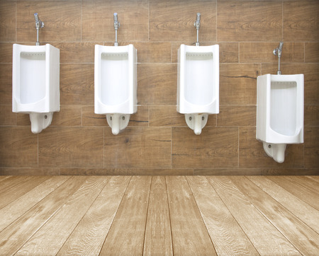 white porcelain urinals in public toilets background pattern.の写真素材