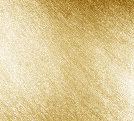 Shiny yellow leaf gold foil texture backgrounの写真素材