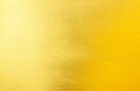 Shiny yellow leaf gold foil texture backgroundの写真素材