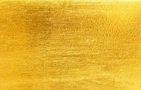 Shiny yellow leaf gold foil texture backgroundの写真素材