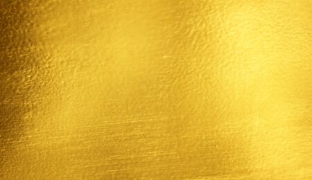 Shiny yellow leaf gold foil texture backgroundの写真素材