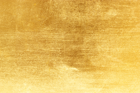 Shiny yellow leaf gold foil texture backgroundの写真素材