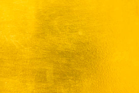 Shiny yellow leaf gold foil texture backgroundの写真素材