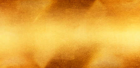 Shiny yellow leaf gold foil texture backgroundの写真素材