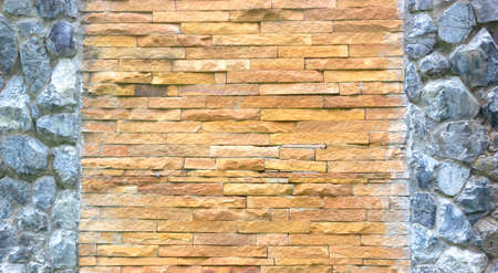 Stone wall decorated with stone and red bricks.