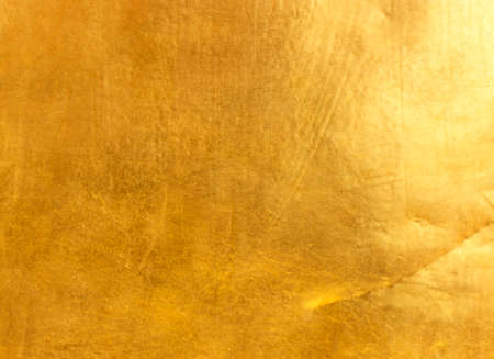Shiny yellow leaf gold foil texture backgroundの写真素材