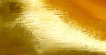 Shiny yellow leaf gold foil texture backgroundの写真素材
