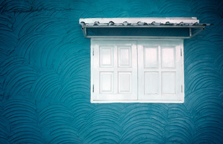white window old blue plaster wall vintage background textureの写真素材