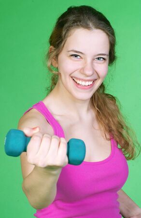 Young smiley woman exercising in fitness studioの写真素材