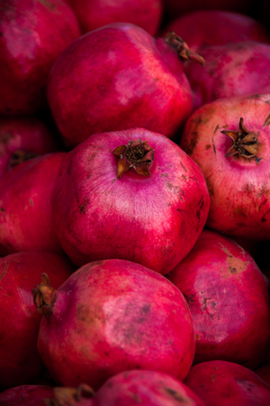Fresh ripe pomegranates on display during the autumn season in Israel.の写真素材