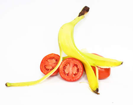 Banana skin and tomatoes insulated on white backgroundの写真素材