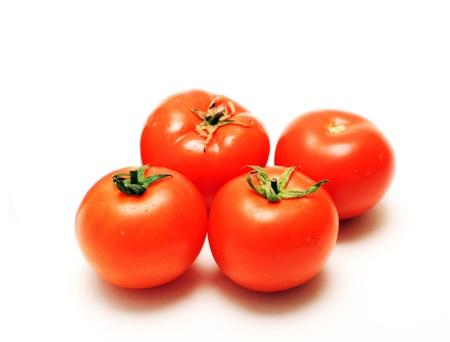 four full tomatoes with water drops isolated on white background の写真素材