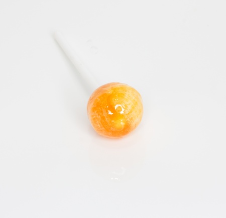 Orange candy isolated in white background の写真素材