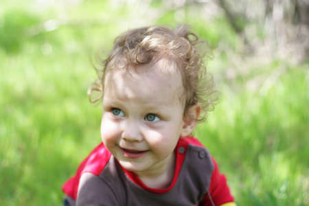 Smiling boy on a green background