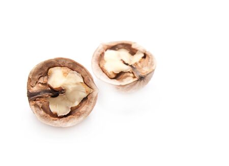 walnut and a cracked walnut isolated on the white background の写真素材