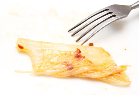 Korean cabbage with chili and a fork on a white backgroundの写真素材