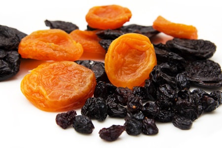 dried apricots, prunes and raisins on a white backgroundの写真素材