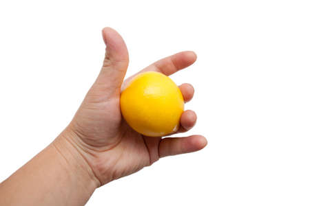 Lemon in a hand on a white backgroundの写真素材