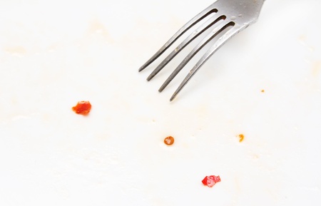 abstract background. pieces of chili with a fork on a white background