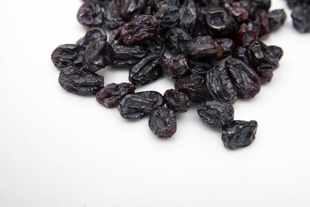black raisins on a white backgroundの写真素材