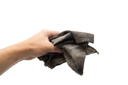 dirty rag in his hand on a white backgroundの写真素材