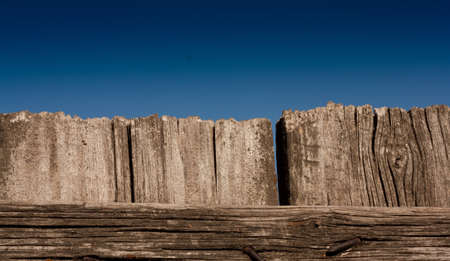 wooden fence against the blue skyの写真素材