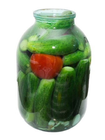 salted cucumber and tomatoes in a jar on a white backgroundの写真素材