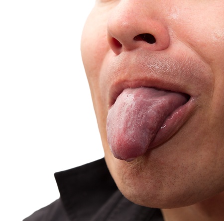 man shows tongue on a white backgroundの写真素材