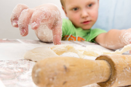 boy rolls the dough