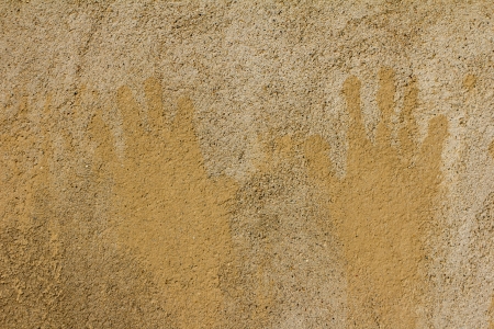 prints of children's hands on a background of concreteの写真素材